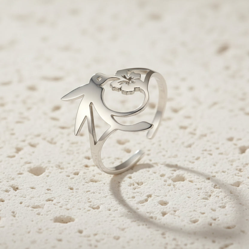 Silver ring with unique design on a beige surface