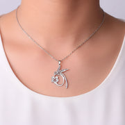 Woman wearing a silver hummingbird flower pendant necklace — spirit animal jewelry