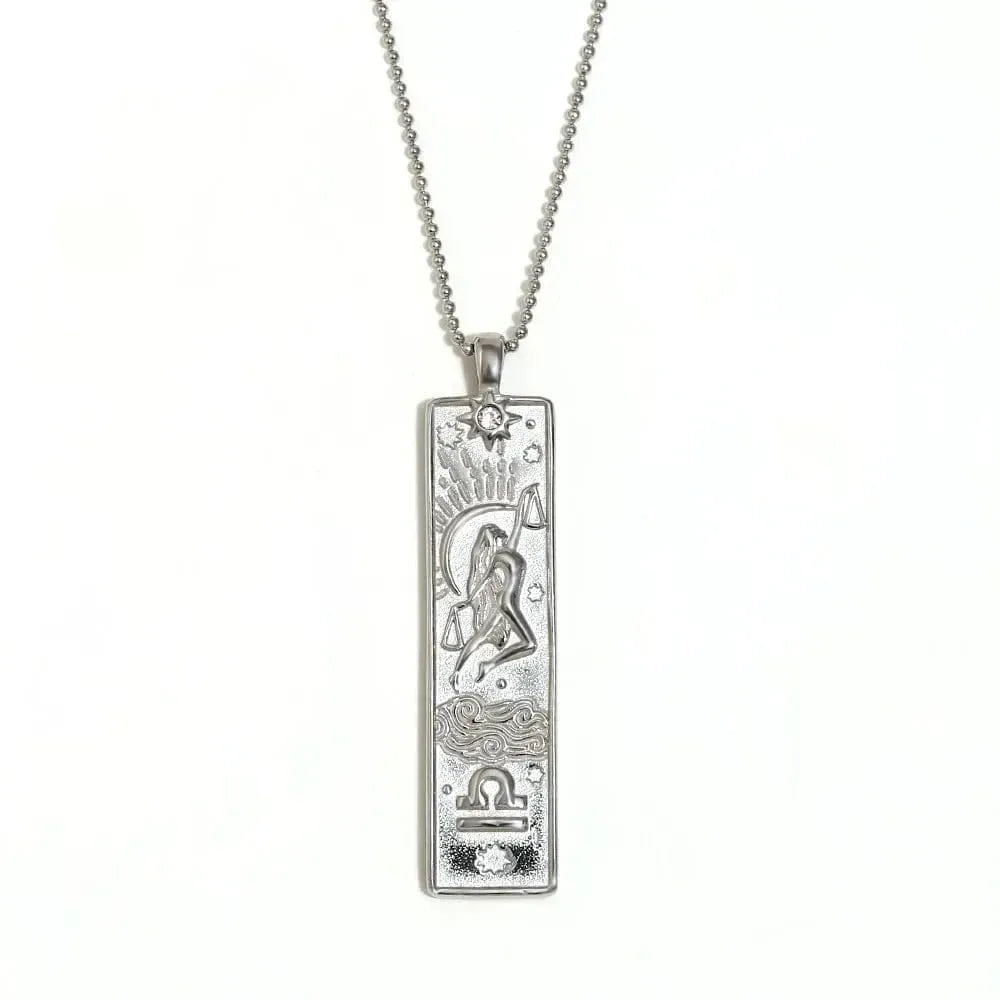 Silver pendant necklace with intricate design on a white background