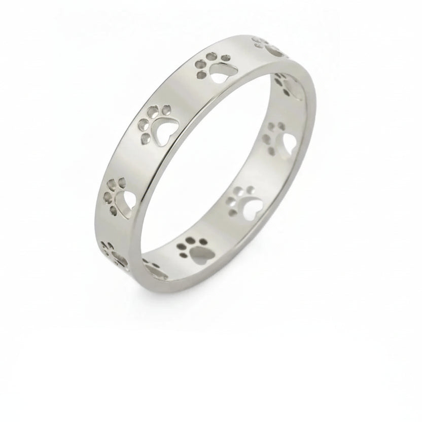 Silver ring with paw print design on a white background