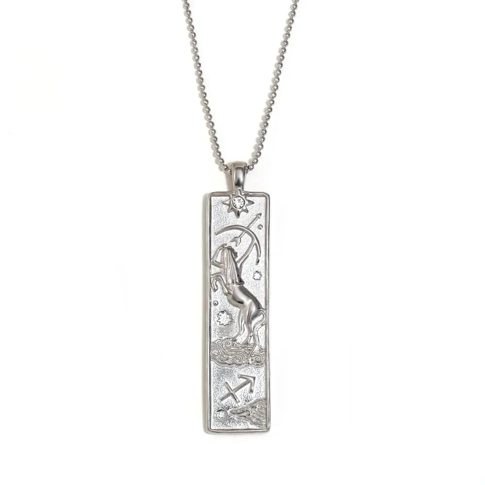 Silver pendant with zodiac design on a white background