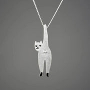 Silver cat-shaped pendant on a chain against a dark gray background
