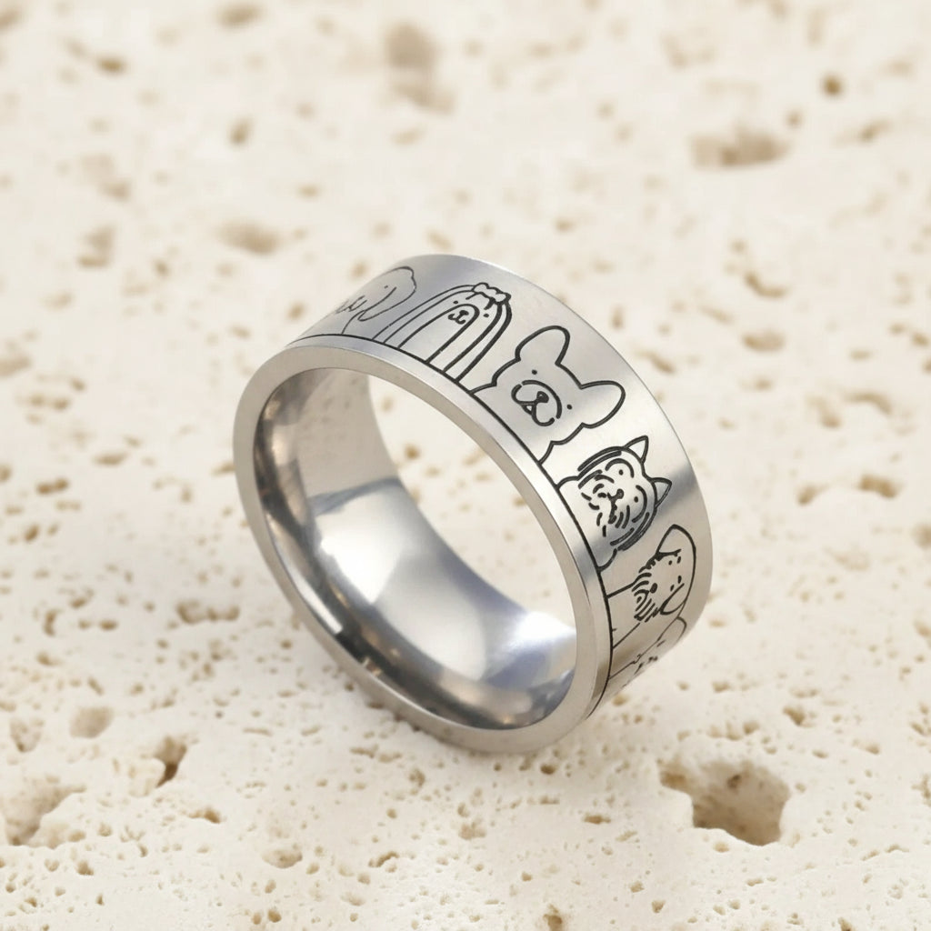 Silver ring with engraved designs on a blue background