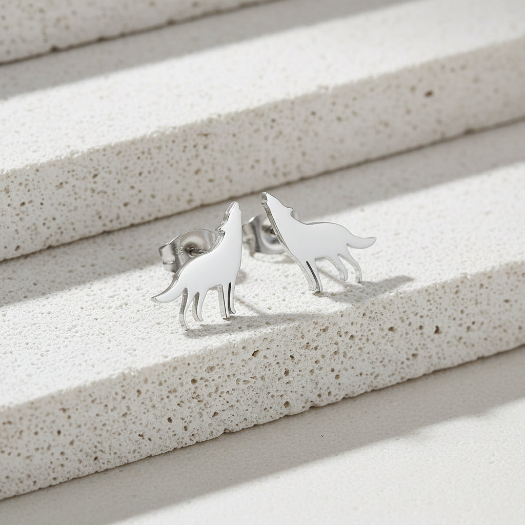 Silver wolf-shaped earrings on a white background