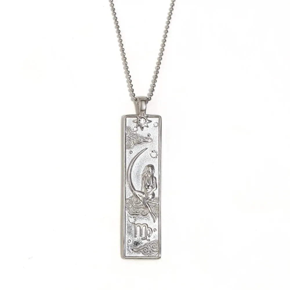 Silver pendant with zodiac design on a white background
