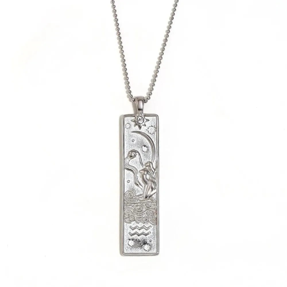 Silver pendant necklace with intricate design on a white background