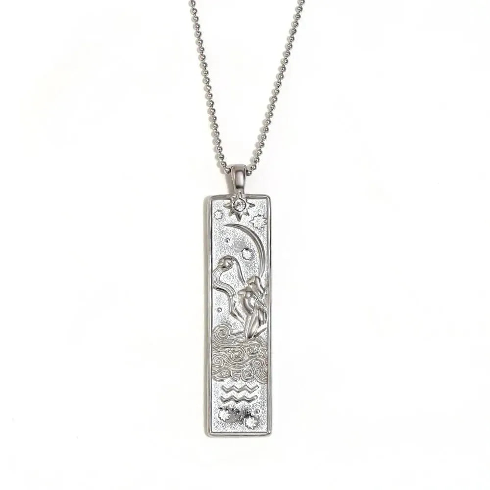 Silver pendant necklace with intricate design on a white background