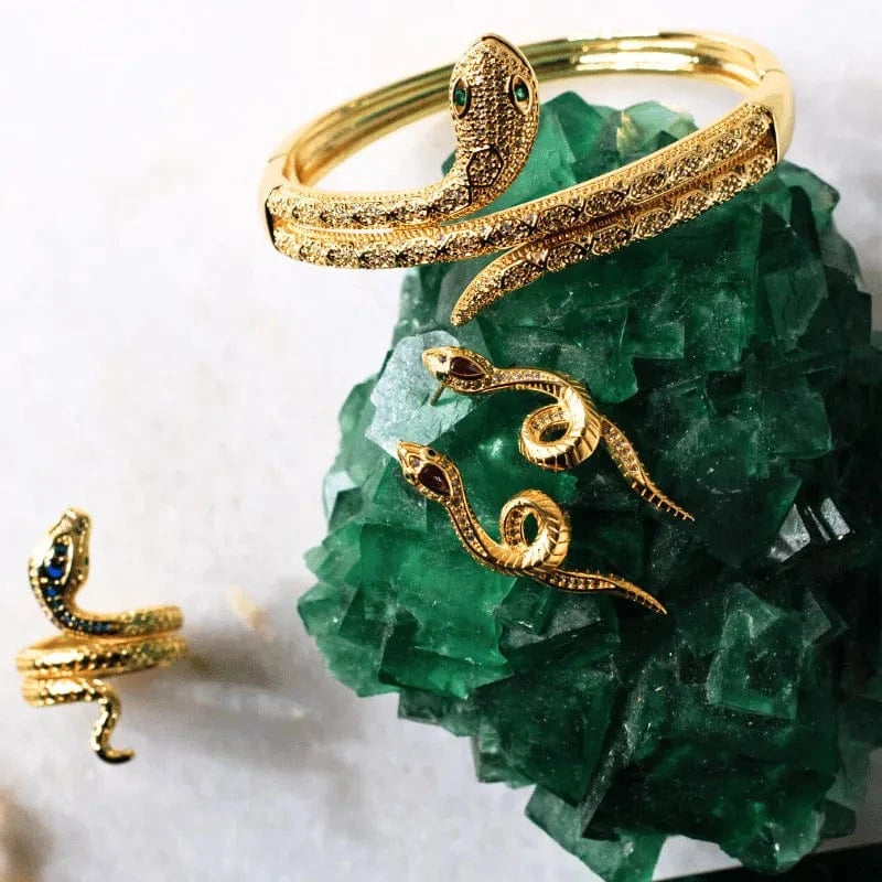 Gold snake-shaped bracelet on a green crystal