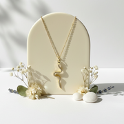 Gold snake pendant necklace hanging — spirit animal jewelry for transformation and rebirth