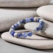 Beaded bracelet with blue and white stones on a white background