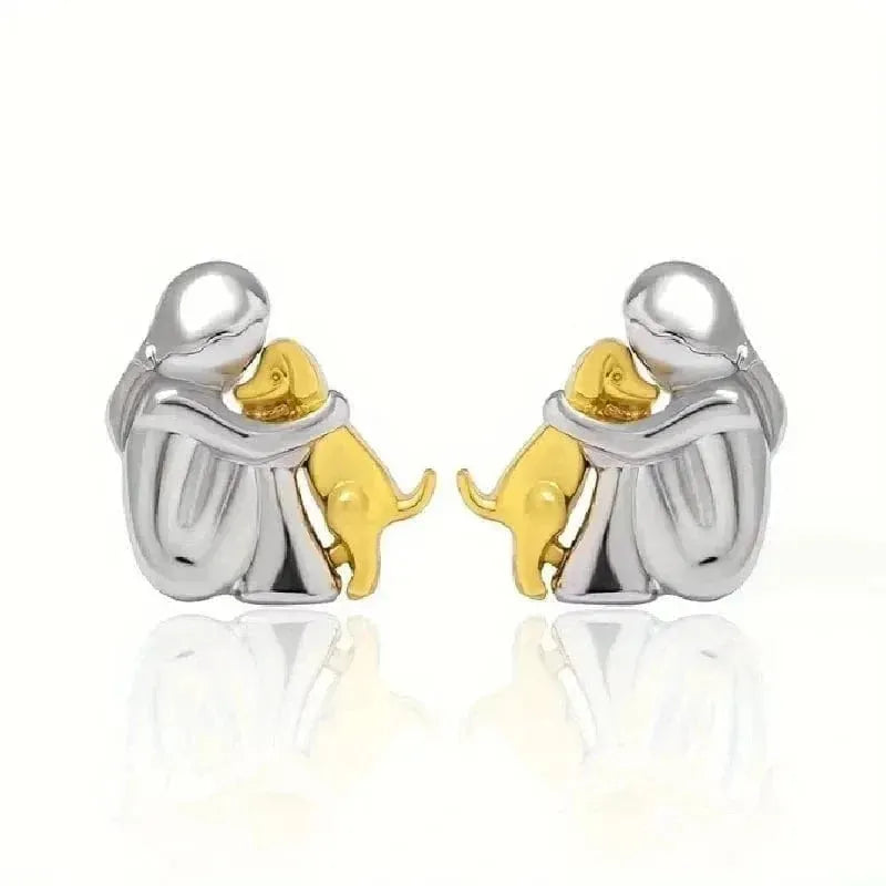 Pair of silver and gold elephant earrings on a white background