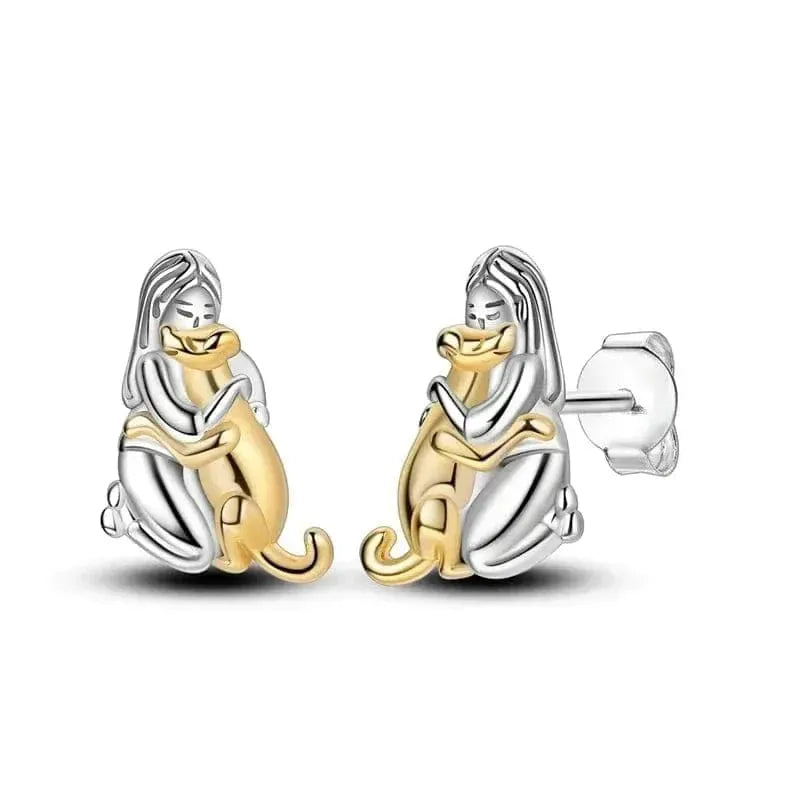 Pair of dog-shaped earrings in gold and silver on a white background