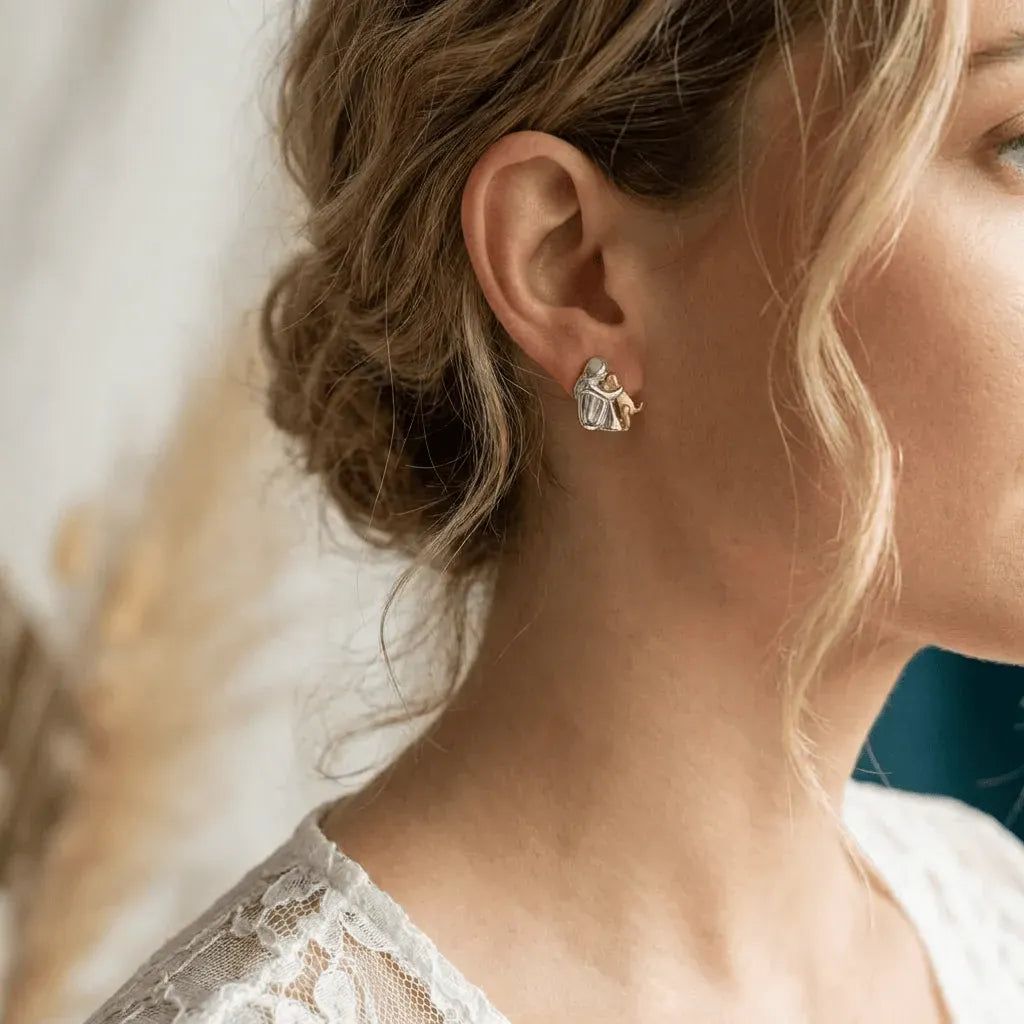 Close-up of a woman wearing a silver earring with a blurred background