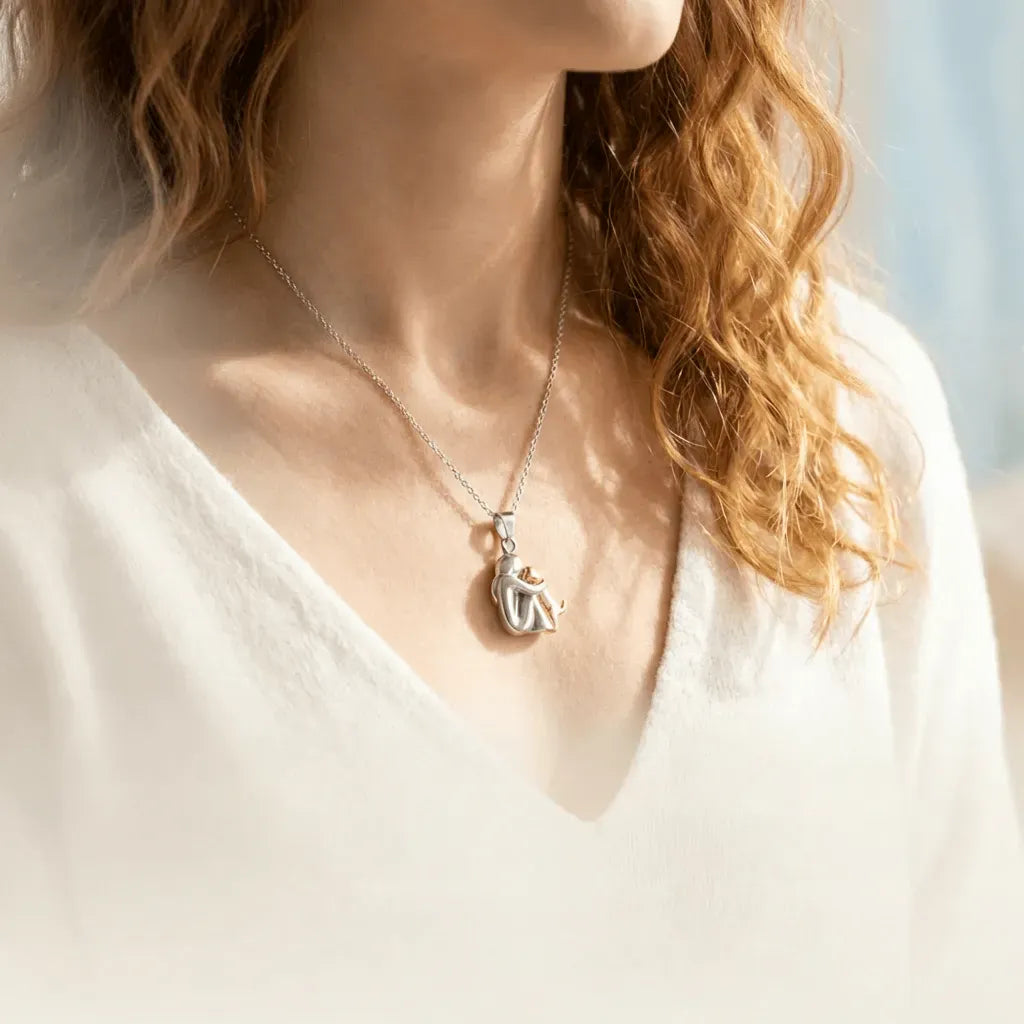 Person wearing a necklace with a pendant, blurred background