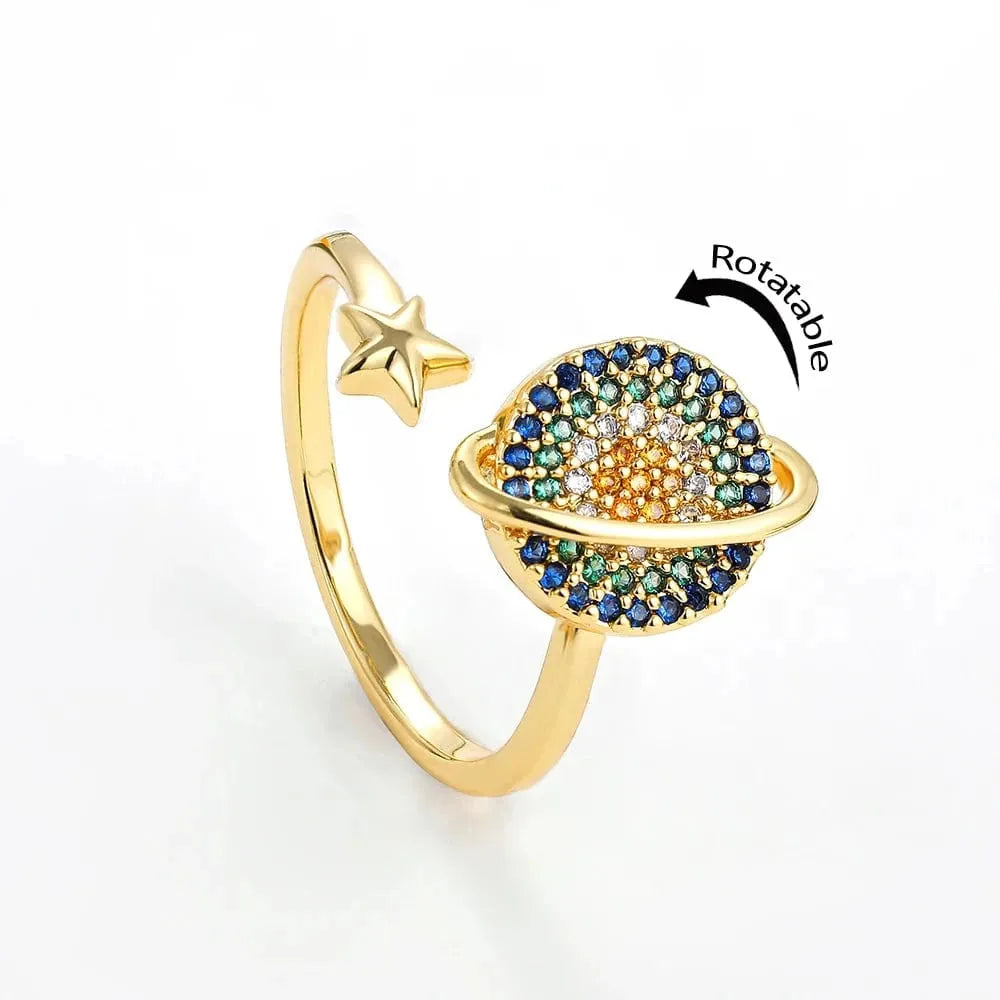 Gold ring with star and gemstone design on a white background