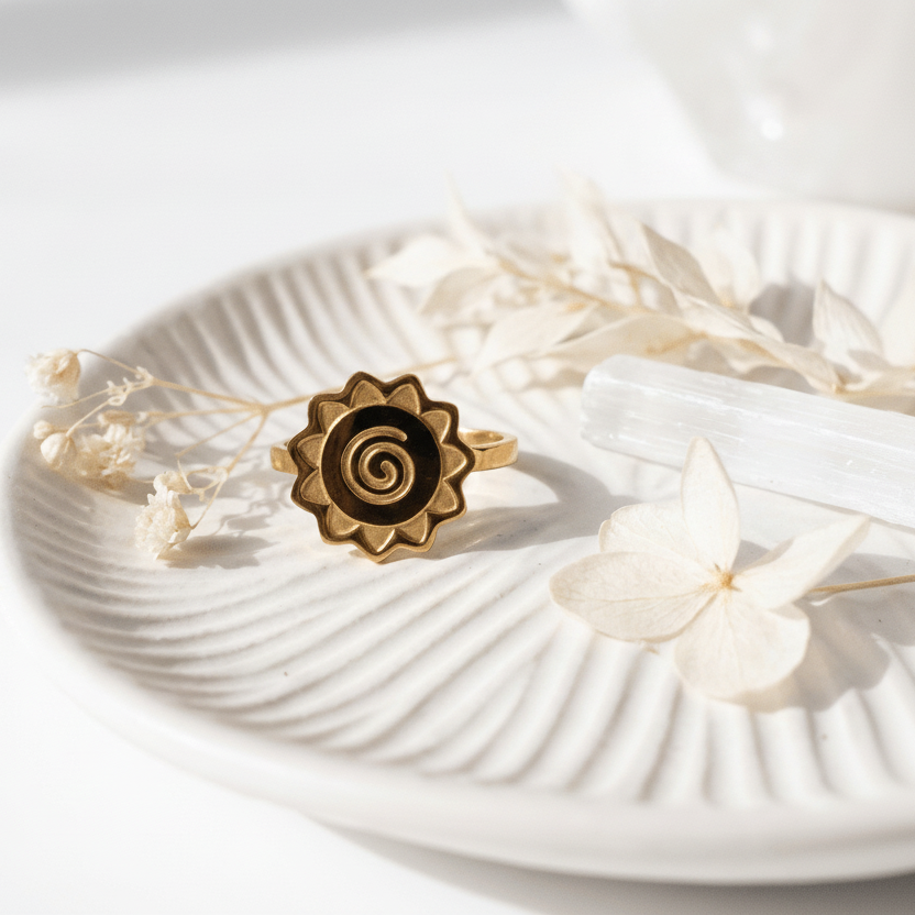 Spiral ring on a white shell with text about transformation journey and material.