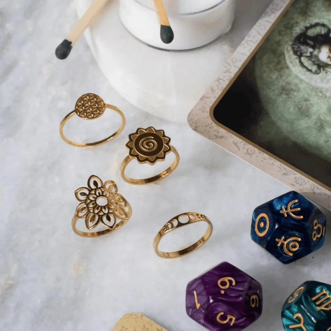 Gold rings and colorful dice on a marble surface