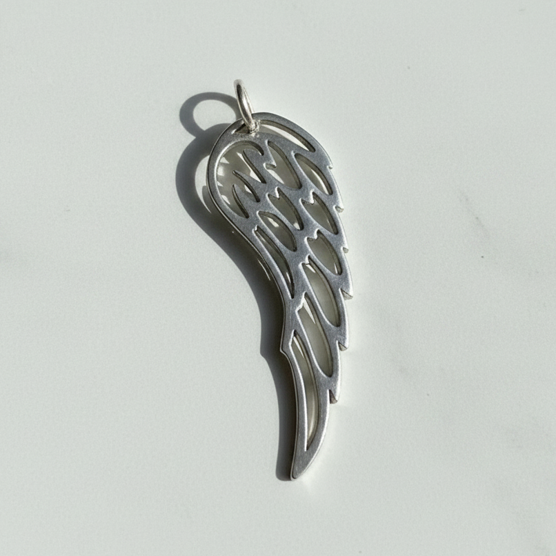Close-up of the sterling silver angel wing pendant — cut-out feather line detail