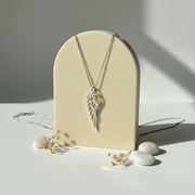 Sterling silver angel wing pendant necklace hanging — spiritual symbol jewelry for protection