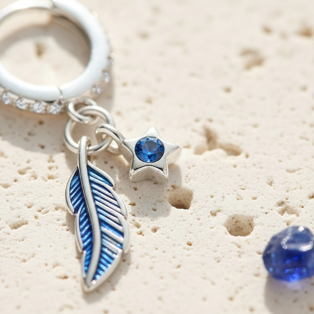 Close-up of the feather detail on sterling silver hoop earrings