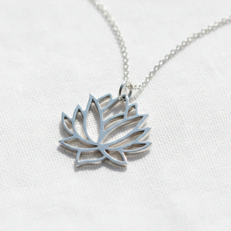 Sterling silver lotus flower pendant with cut-out bloom detail — spiritual symbol jewelry