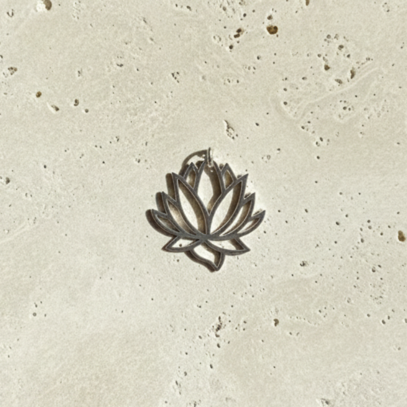 Close-up of the sterling silver lotus flower pendant — open cut-out bloom design