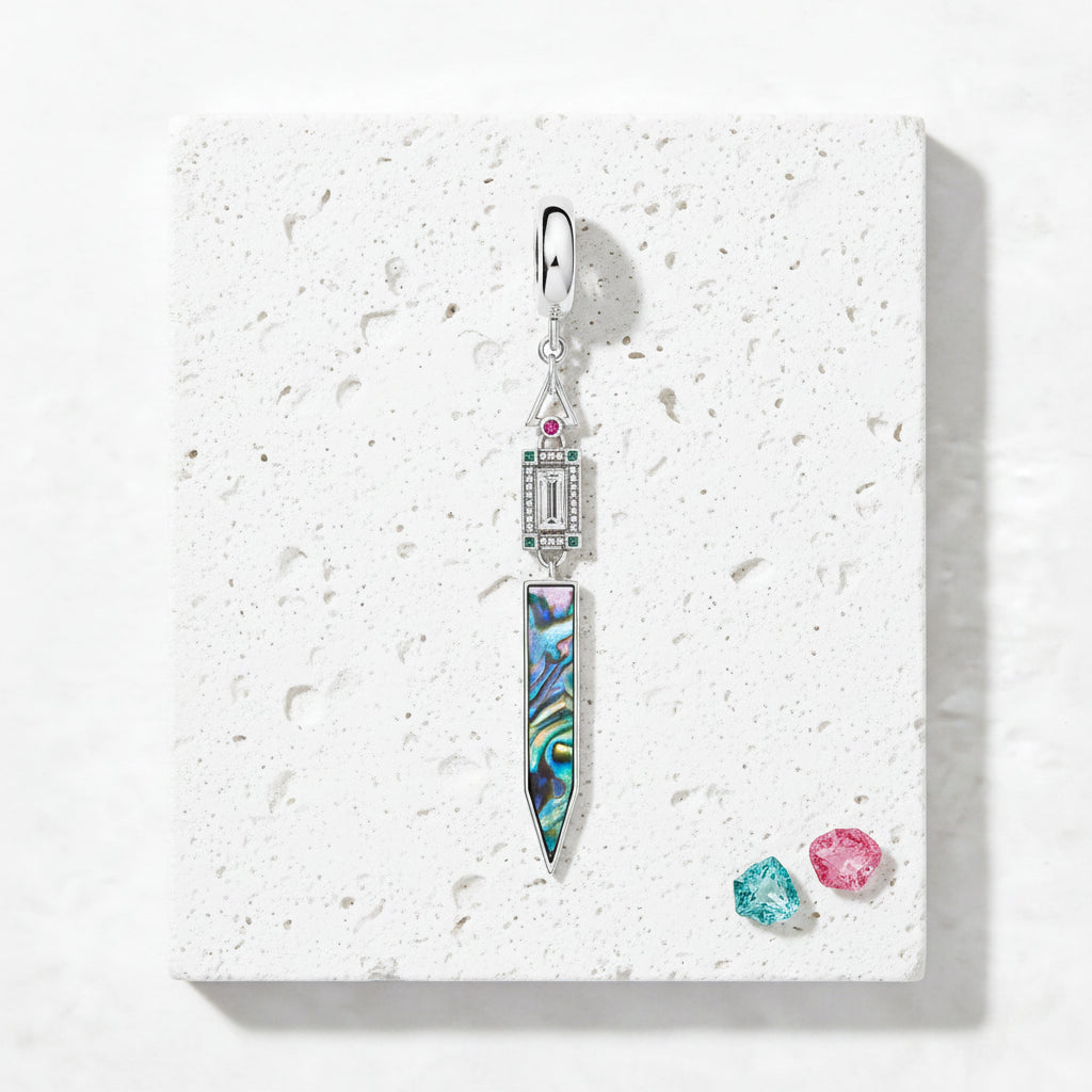 Sterling silver paua shell pendant showing green and blue iridescence