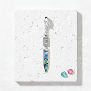 Sterling silver paua shell pendant showing green and blue iridescence