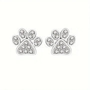 Paw print earrings with clear gemstones on a white background