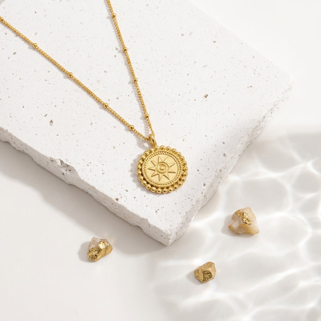 Gold sun medallion pendant necklace — celestial jewelry for warmth and vitality