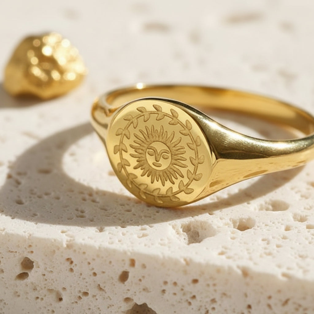 Close-up of the 18K PVD gold sun ring face and engraved sun rays