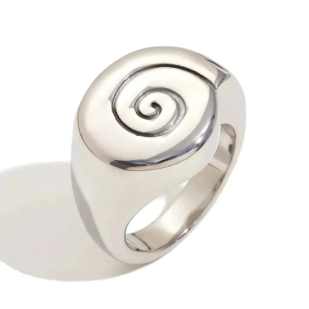 Silver ring with a spiral design on a white background