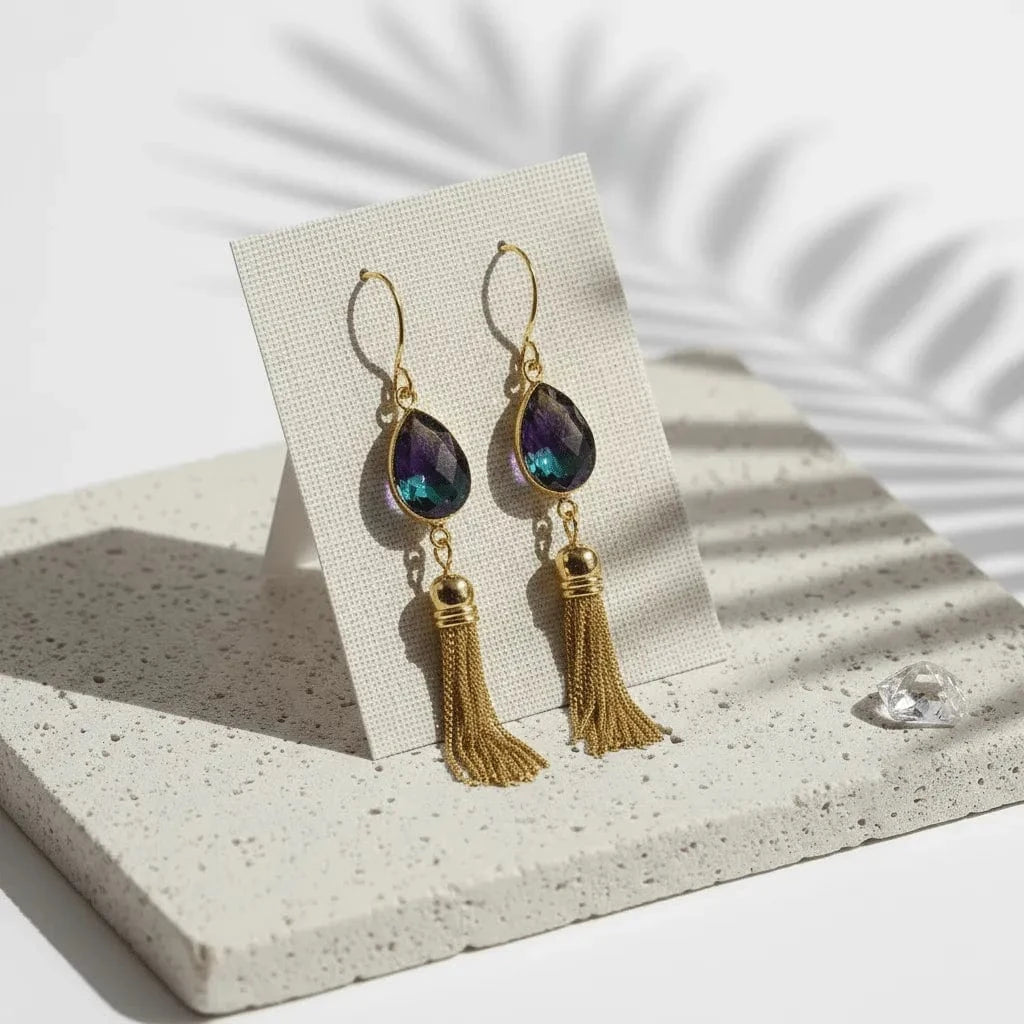 Gold earrings with tassels on a white background