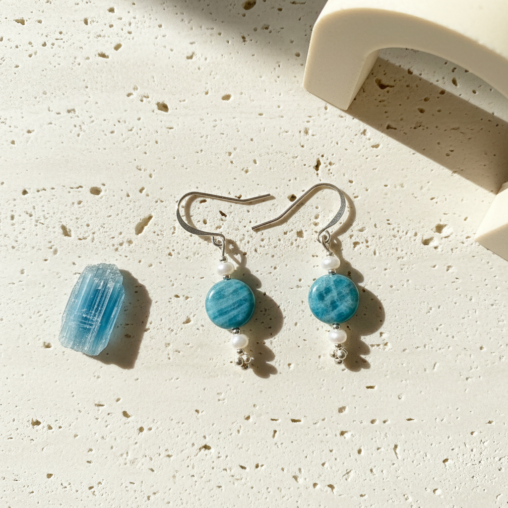 Pair of teal kyanite coin drop earrings with natural darker veining through the stone