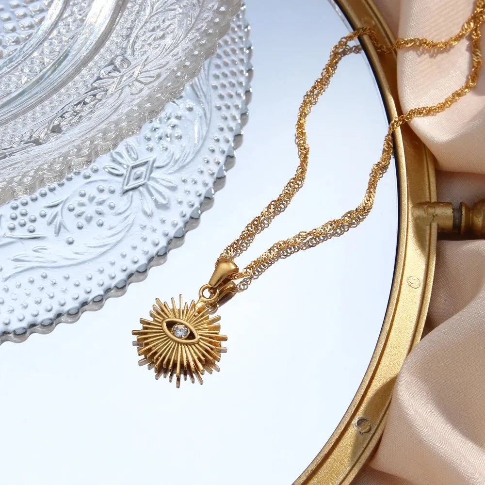 Gold necklace with a decorative pendant on a decorative plate
