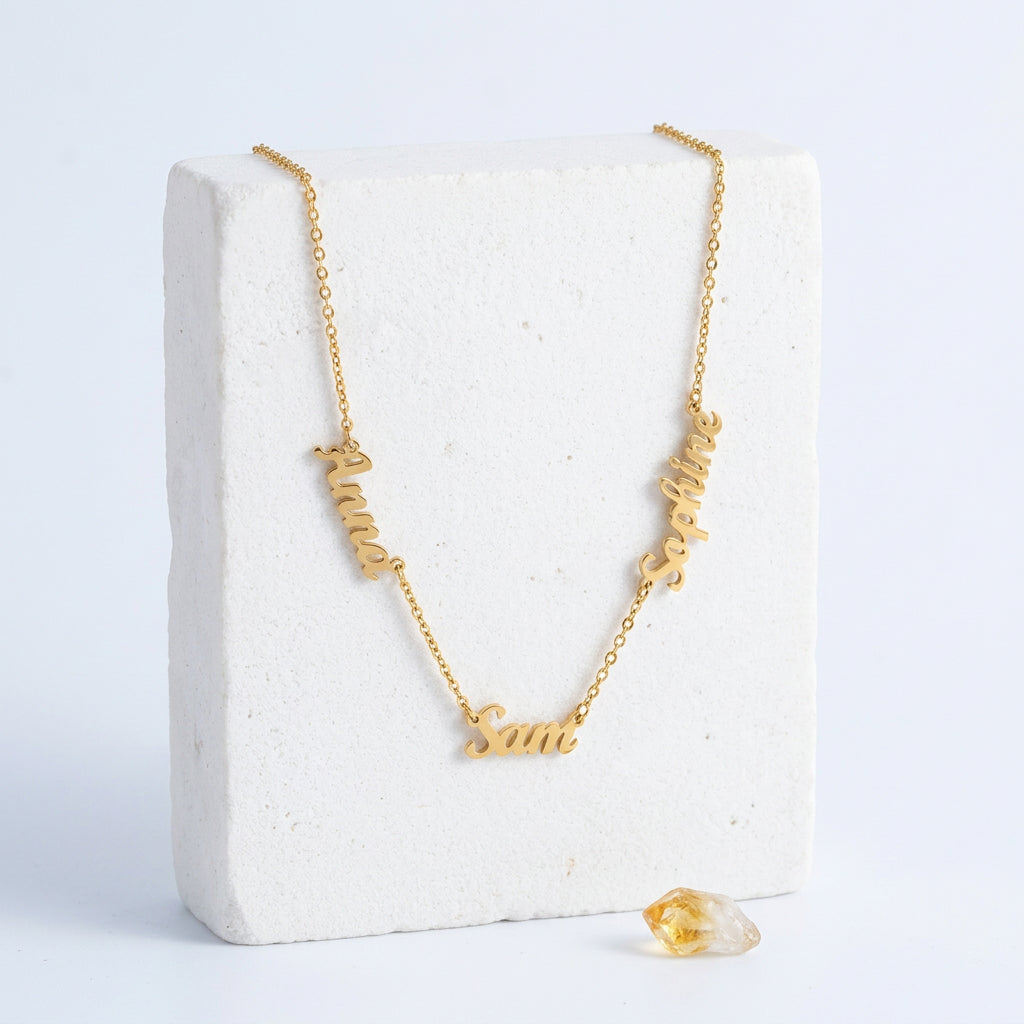 Gold custom name necklace with three names in an alternate script font