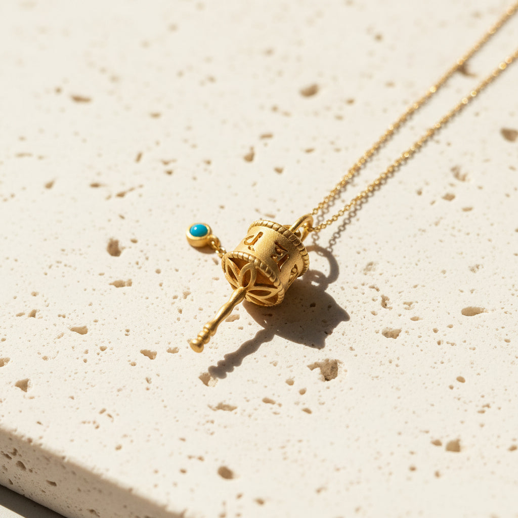 Tibetan prayer wheel pendant necklace in sterling silver with 22k gold plating on a gold-plated chain