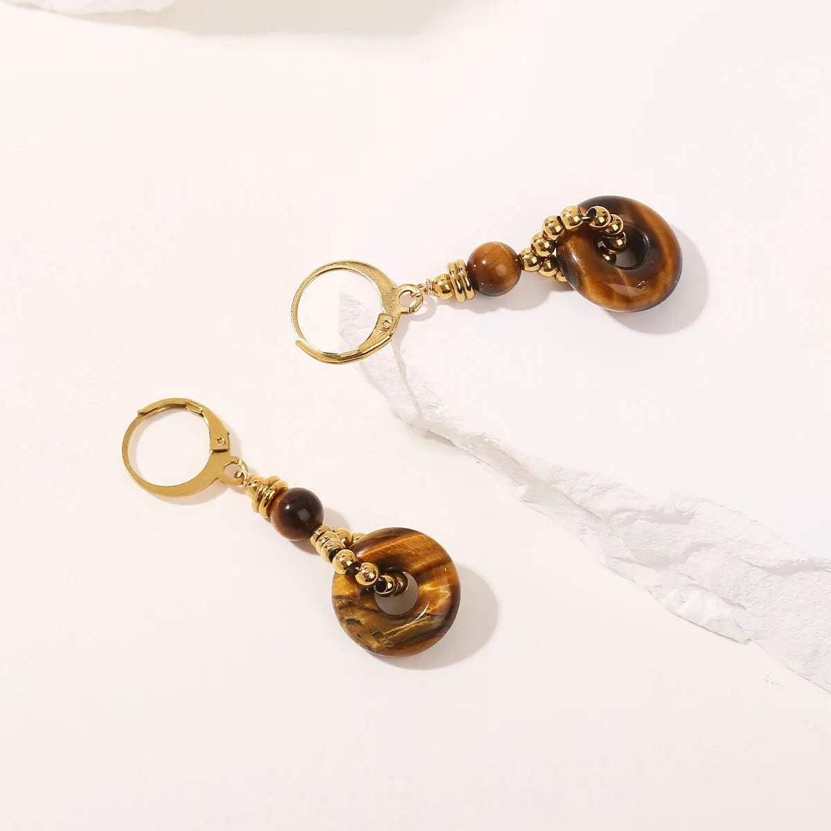 Tiger eye earrings with gold accents on a white background