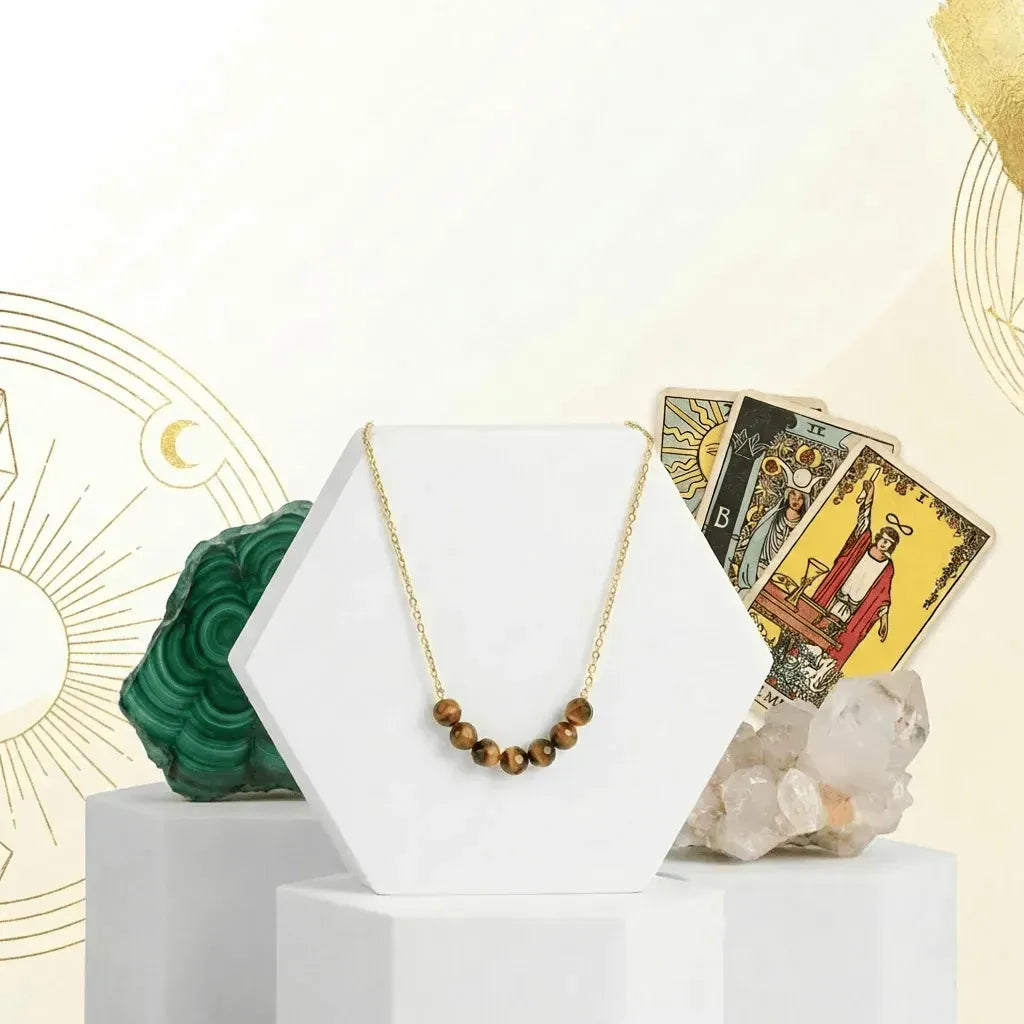 Necklace displayed on a white stand with tarot cards and crystals in the background
