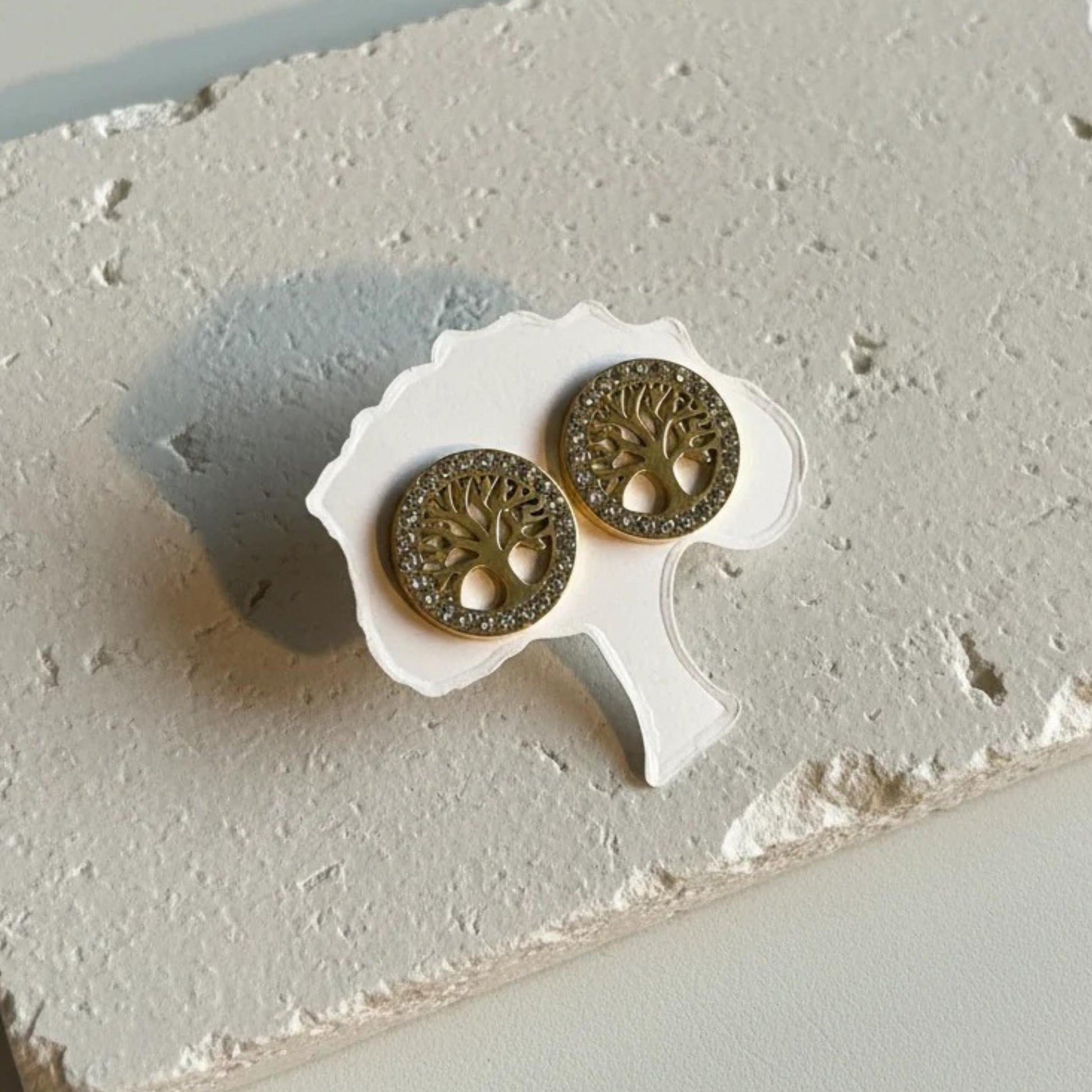 Cut-out tree of life stud earrings ringed with crystals in gold — spiritual symbol jewelry