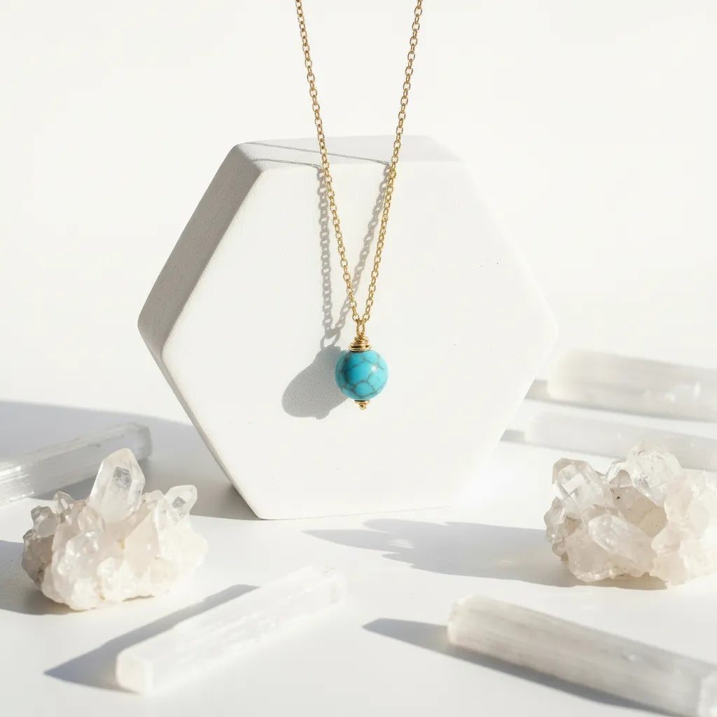 Lapis Lazuli Gold necklace with a pendant on a white surface with crystal-like objects