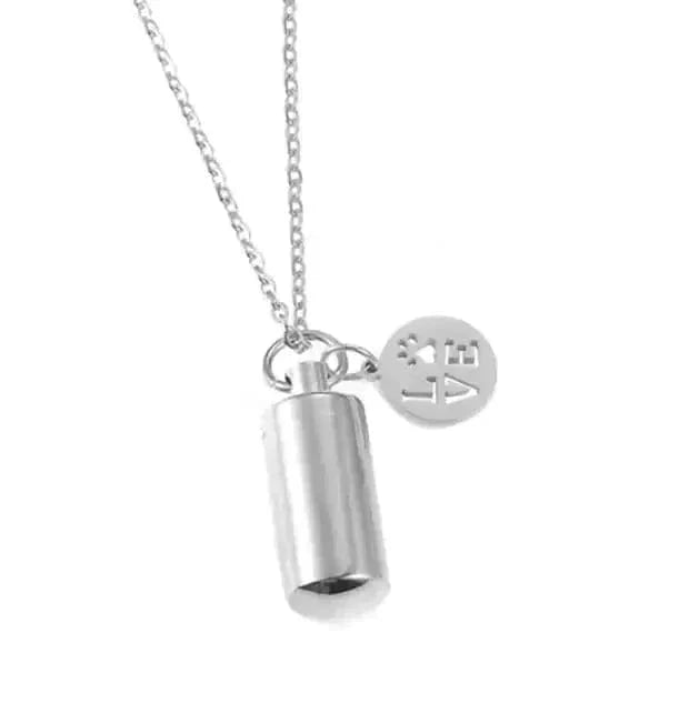 Silver cylindrical pendant necklace with a round tag on a white background