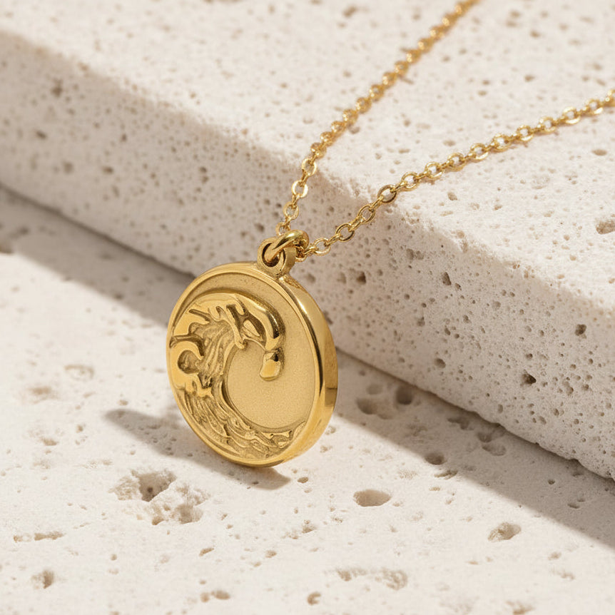 Gold necklace with a pendant on a white background