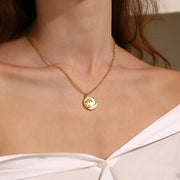 Woman wearing a gold wave pendant necklace — ocean spirit necklace for flow and calm