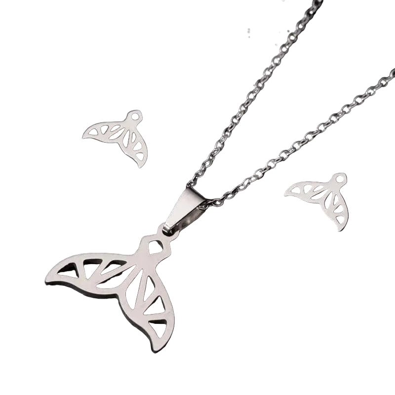 whale jewelry set in silver on white background