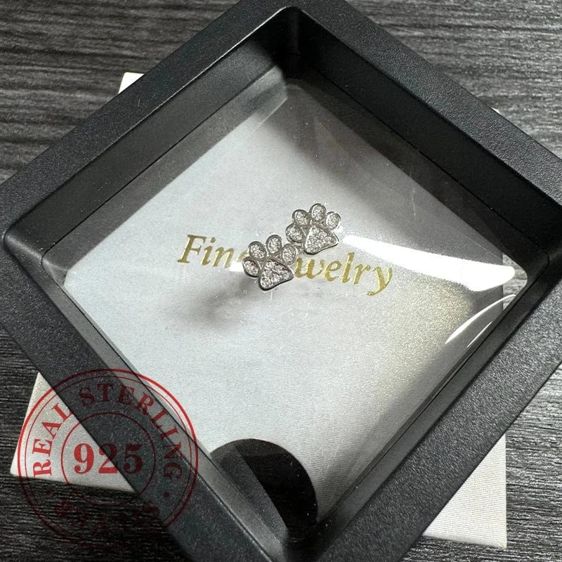 Diamond-studded paw-shaped earring in a 'Fine Jewelry' box with 'Real Sterling 925' stamp.