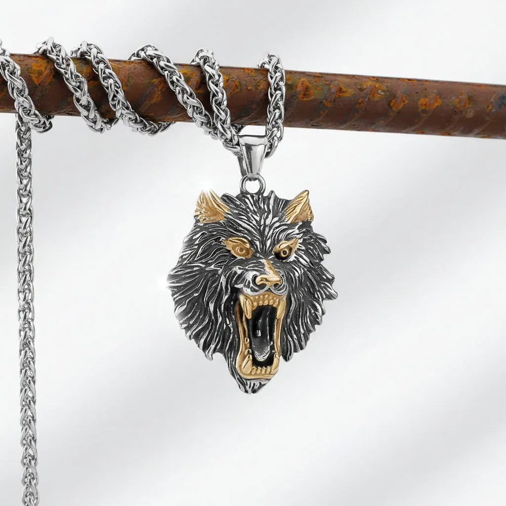 Wolf head pendant on a chain against a dark background