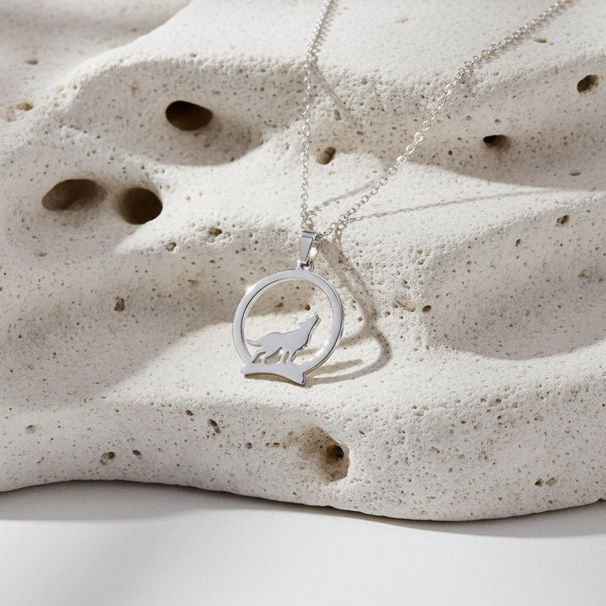 Silver necklace with a wolf pendant and measurements on a white background