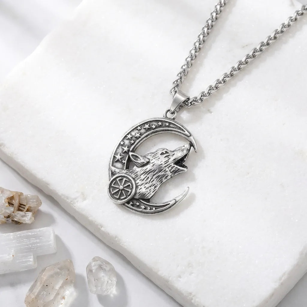 Silver necklace with wolf design on a white surface