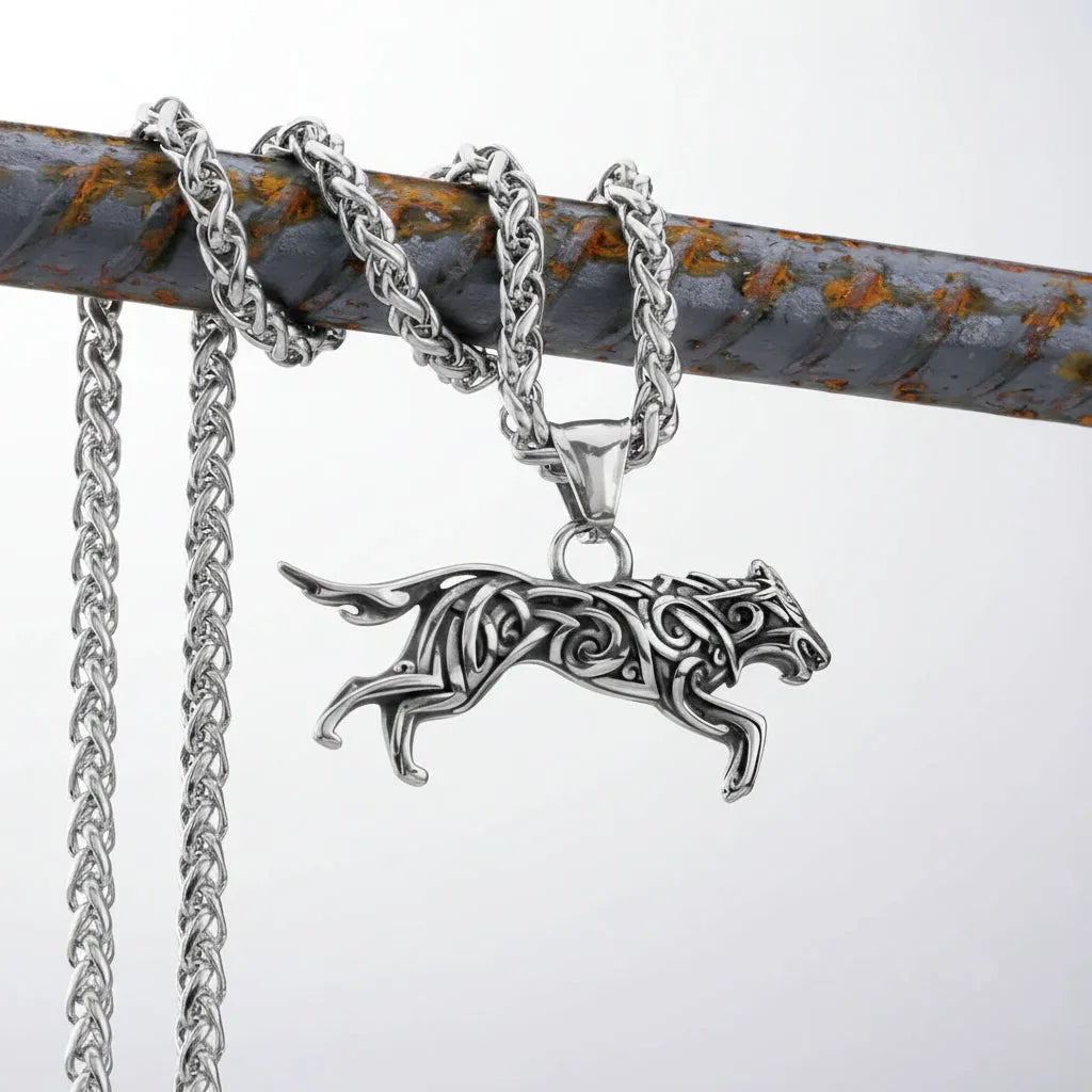 Silver chain with a detailed silver panther pendant on alight background